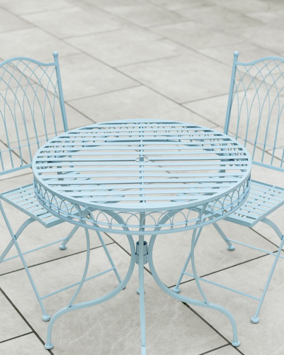 Close up of table top detail with parasol hole detail on patio two seater table and chairs set