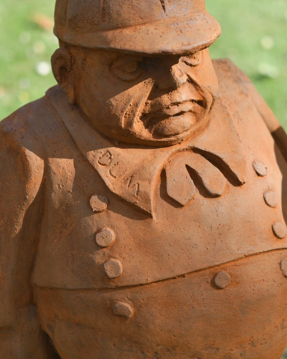Close up of intricate uniform detail on rustic tweedledum sculpture