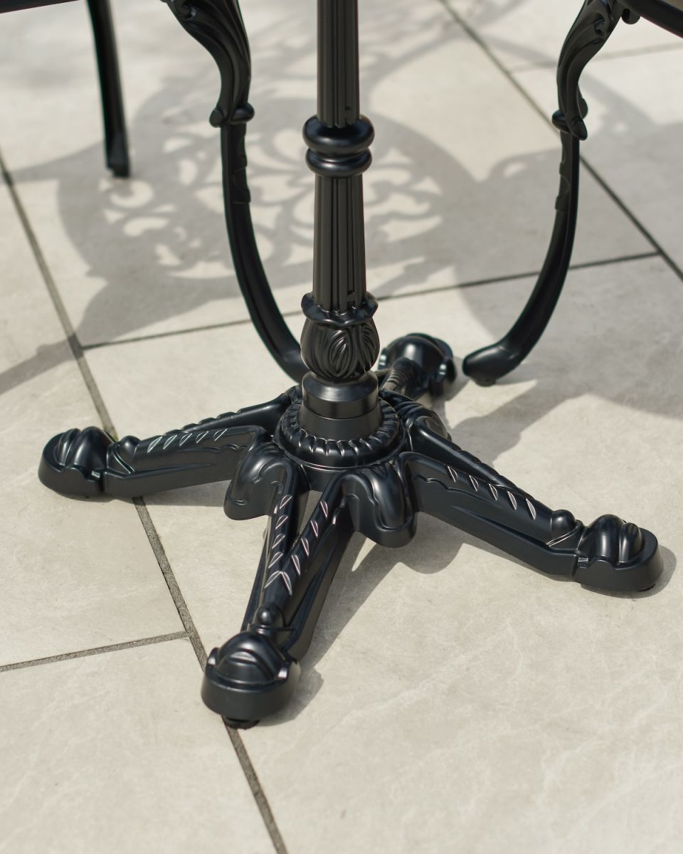 Close up of ornate table leg detail on outdoor two seater dining set