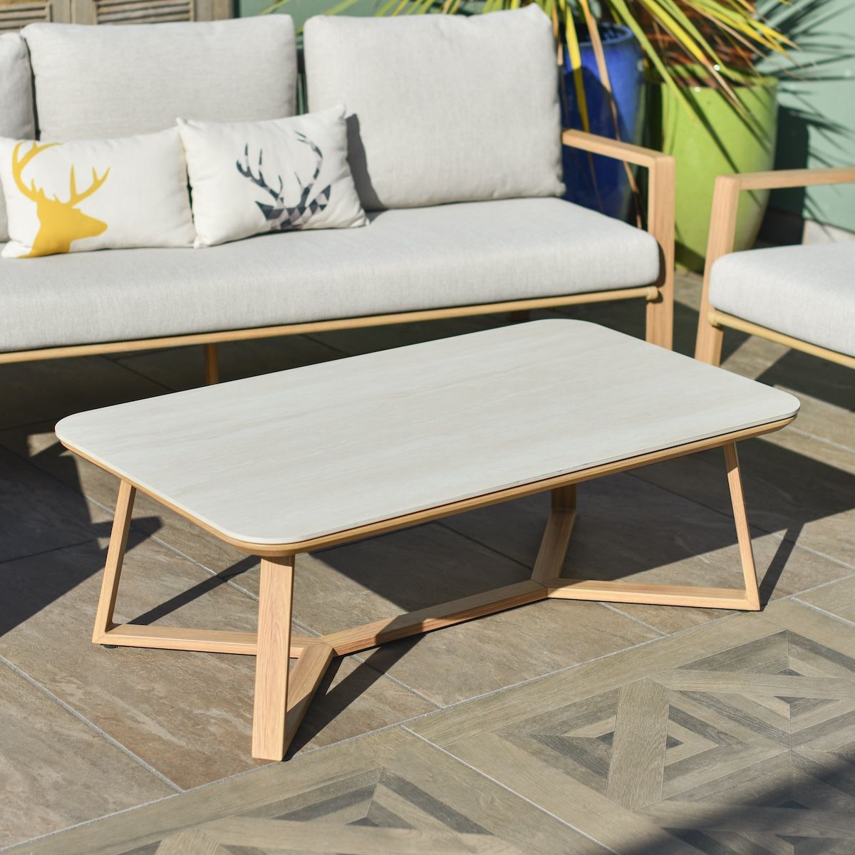 Close up of engineered stone top on coffee table on garden lounge furniture set Close up of engineered stone top on coffee table on garden lounge furniture set