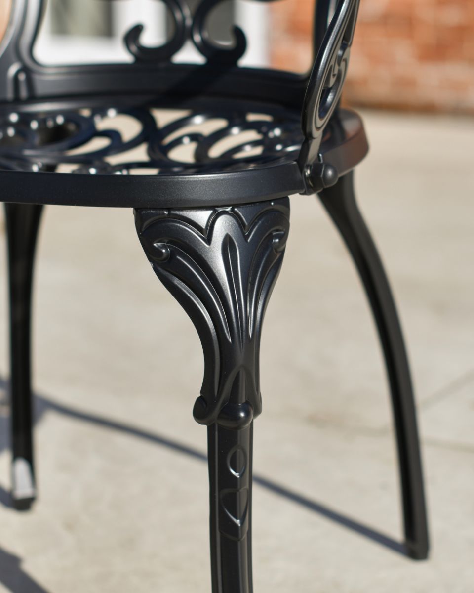 Close Up Of The legs From The Aged Black "Harlington" Table & Chair Set