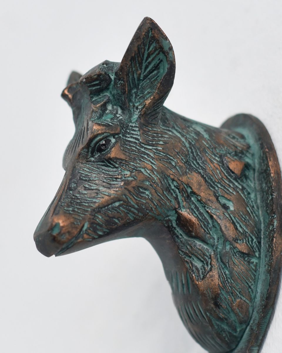 Close up of intricate deer head detail on coat hook