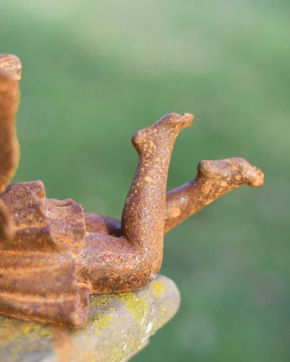 Close up of leg detail on cast iron fairy garden statue