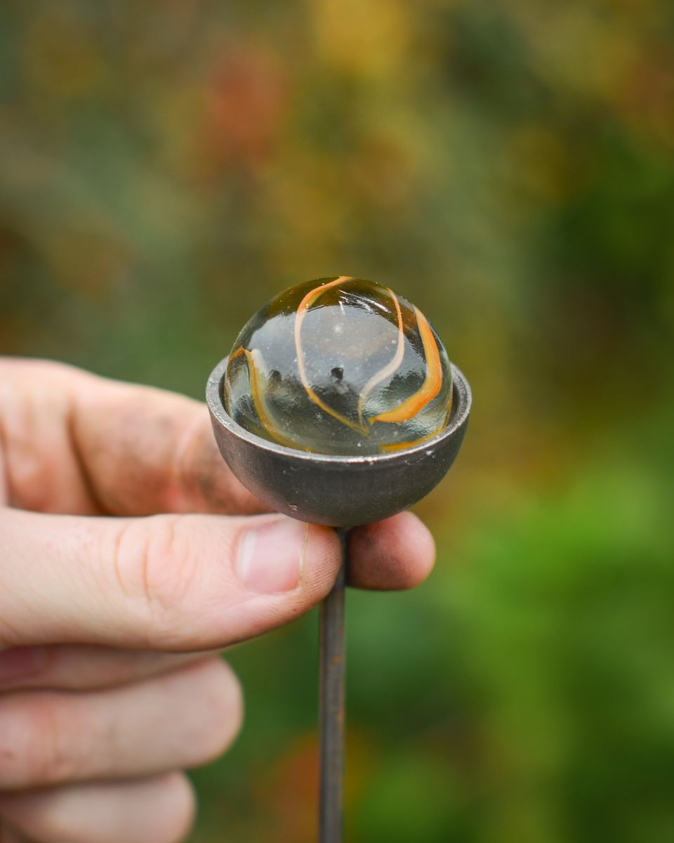 Close up scale image of marble on suncatcher plant pot stake