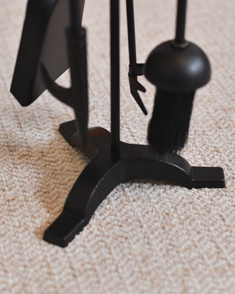 Close up of freestanding base on black fireside companion set