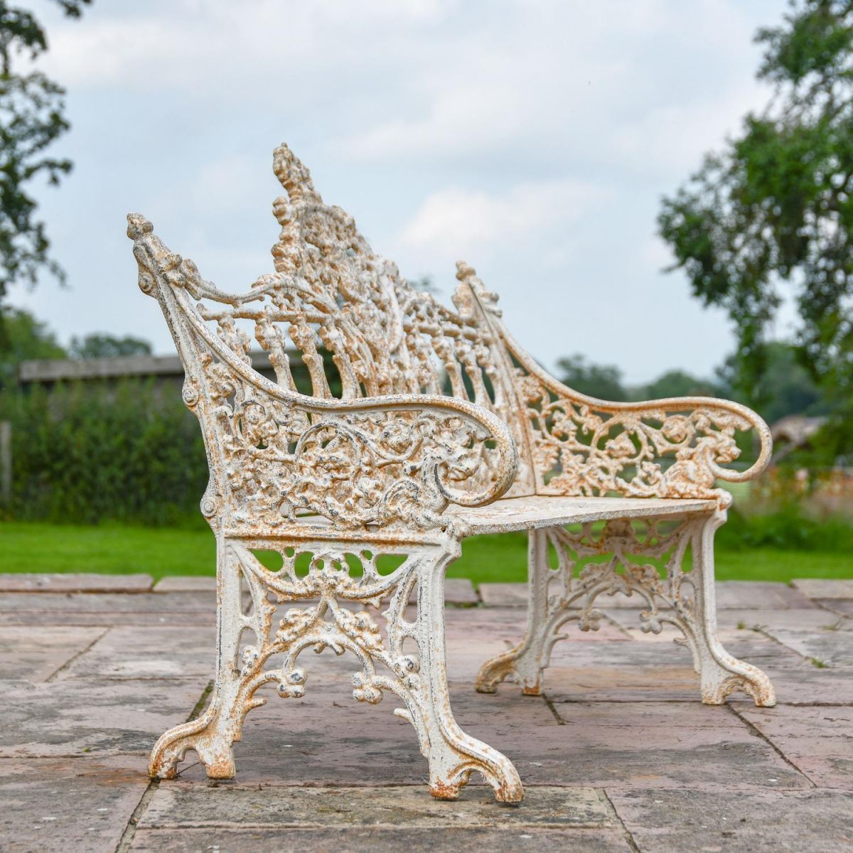 Side view of Antique Cream Cast Iron Gothic Bench in Situ 