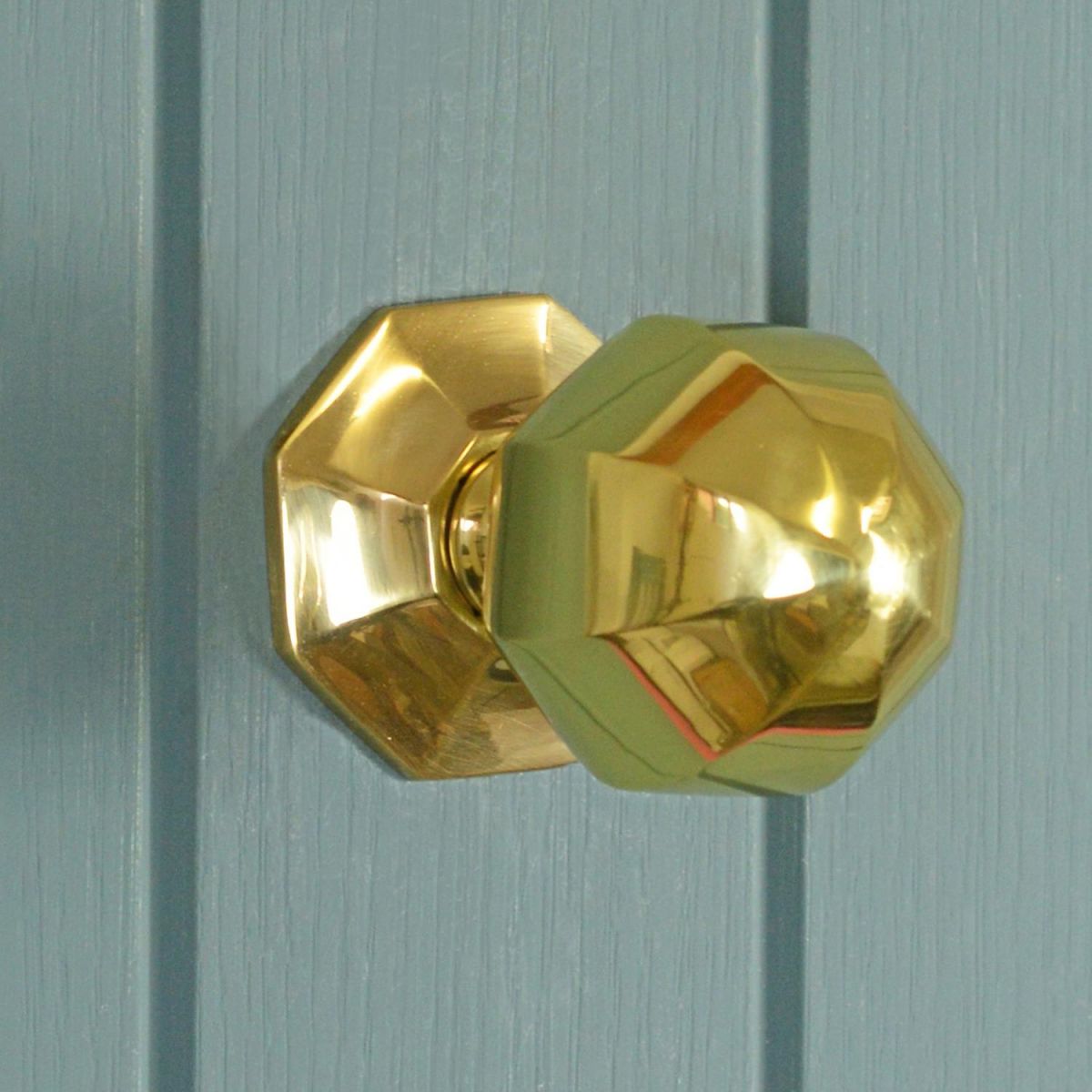 Polished Brass Octagonal door knob on blue door