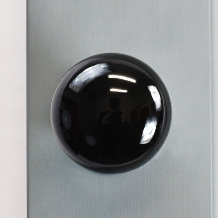 Above View of the Black Ceramic Door Knob on a Grey Door