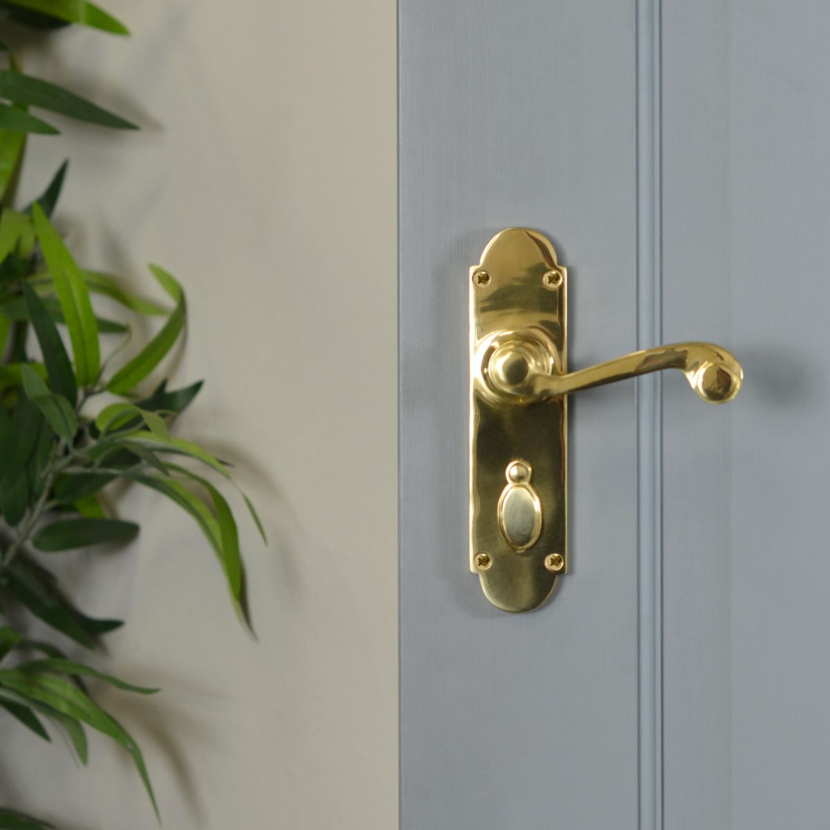 Polished Brass 6 Inch Lever Lock Handles on Grey Door in Situ