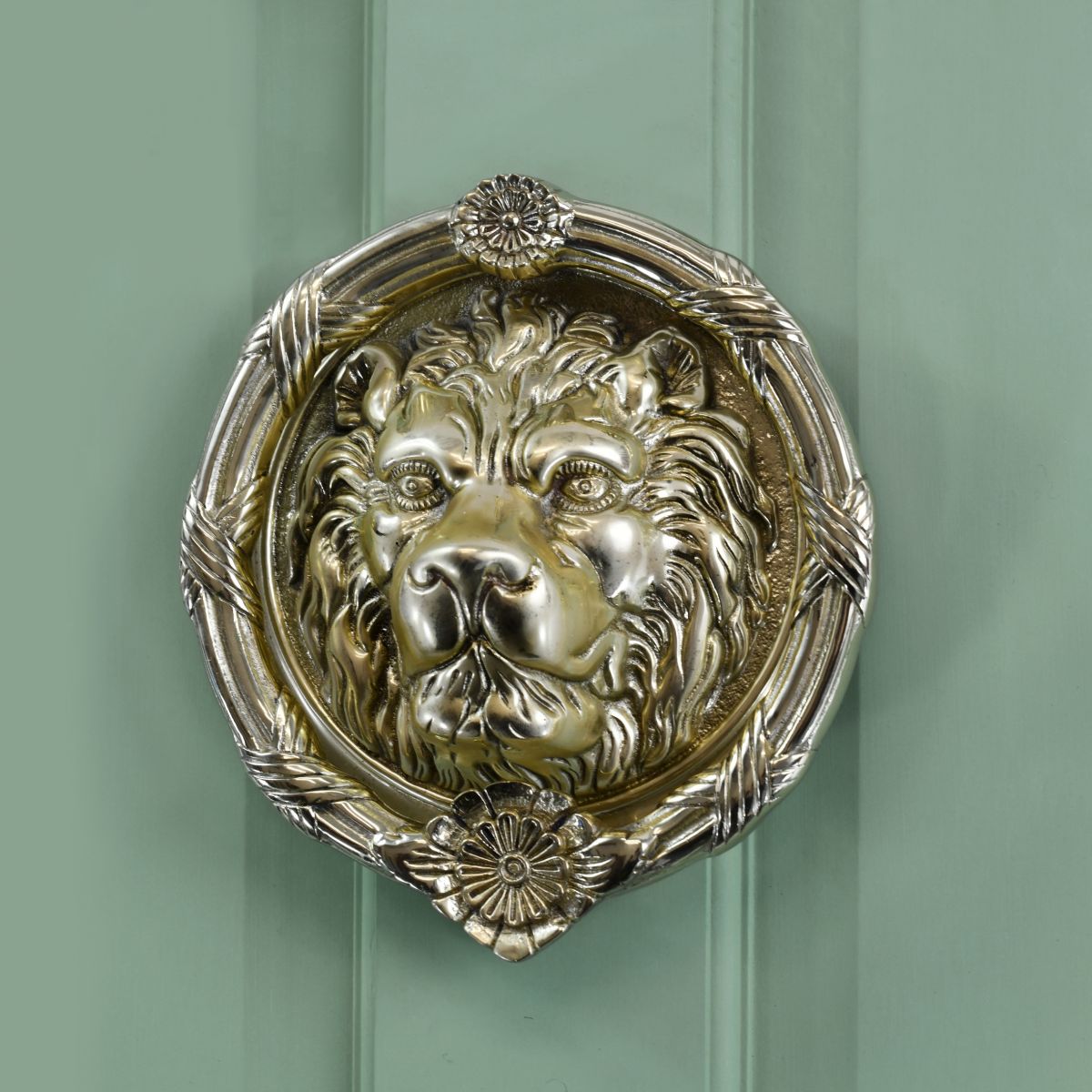 Polsihed Brass round Regal lion door knocker on Pastel green door