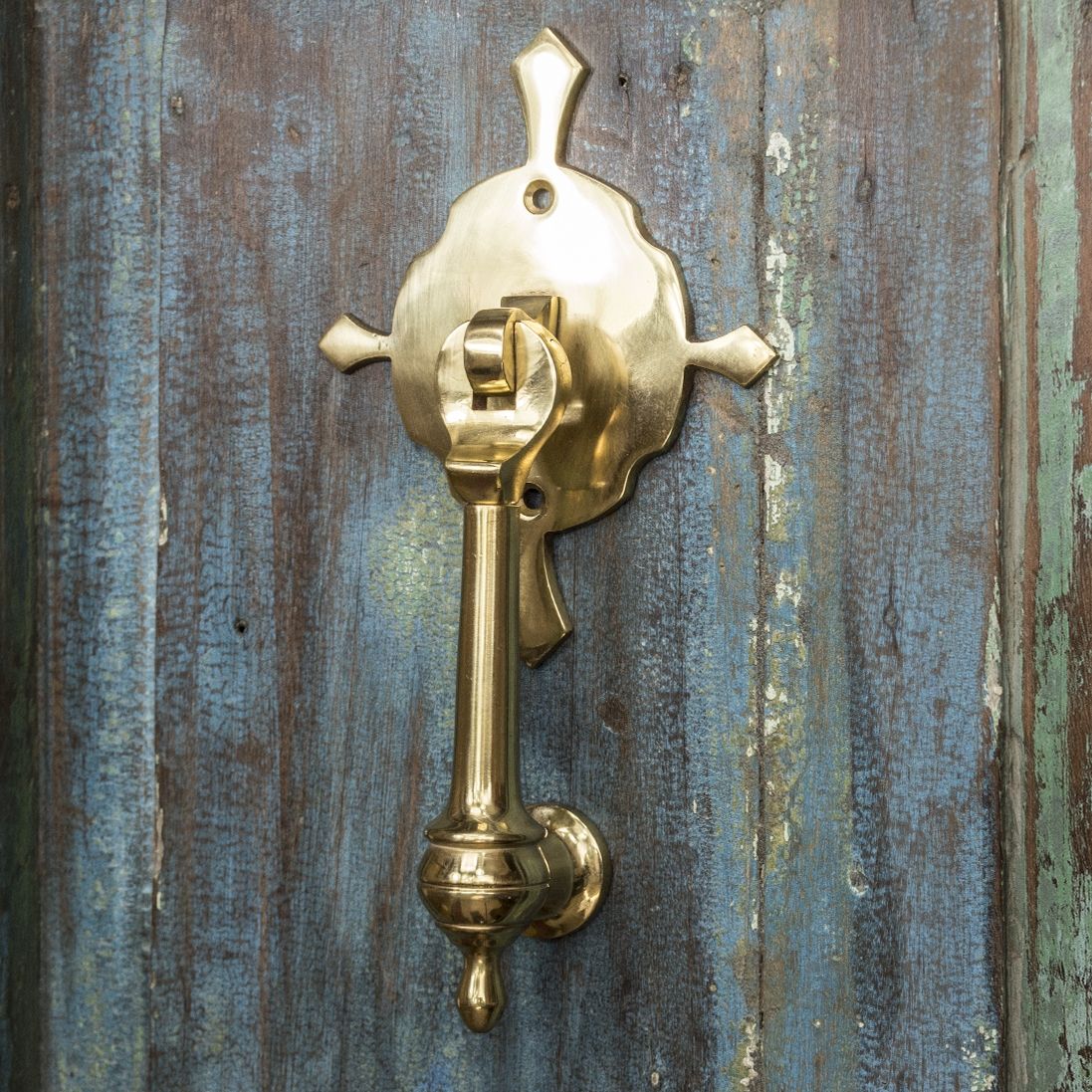 Polished Brass Turnbrook Park door knocker on Old Wooden Door