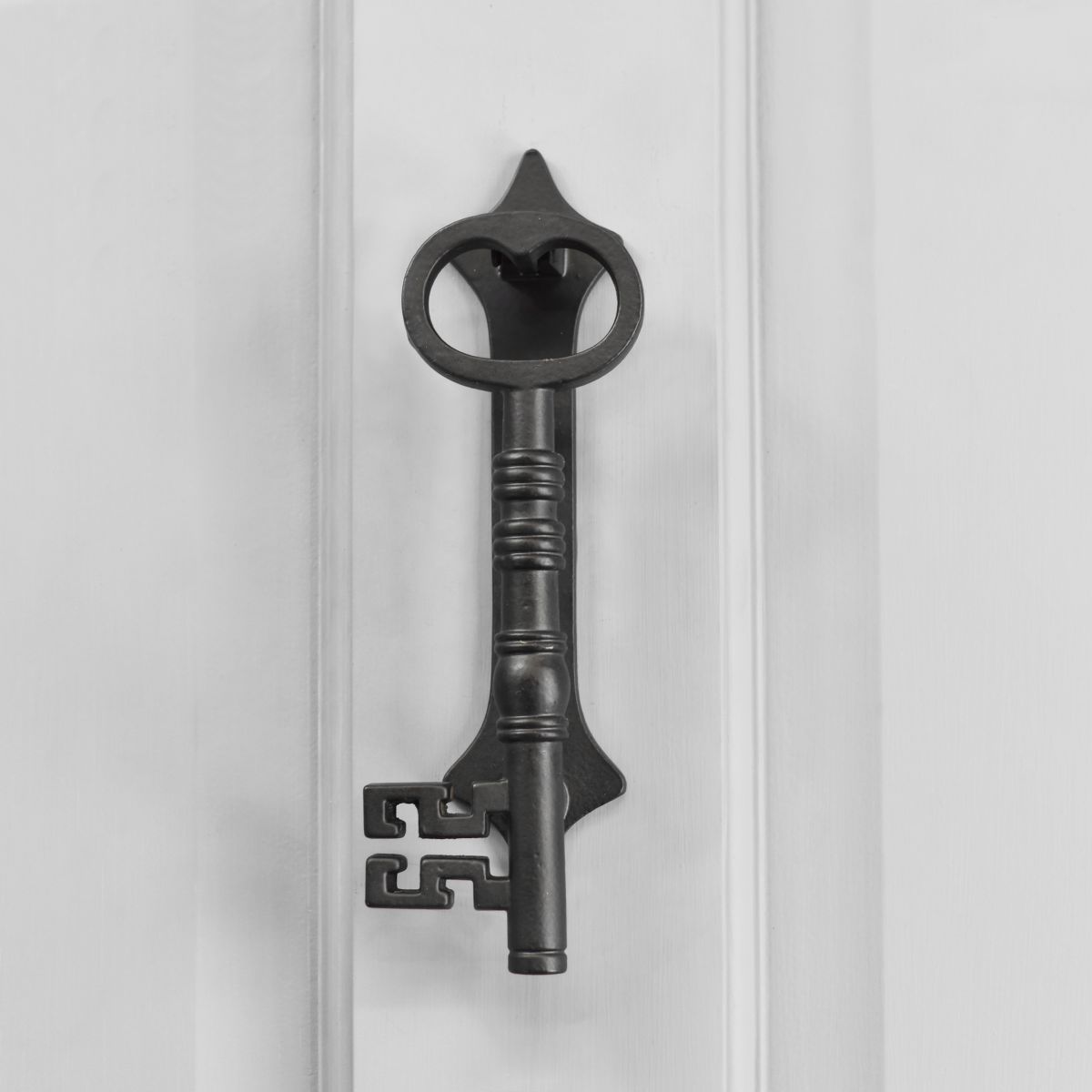 Beautiful detailed key door knocker on grey door