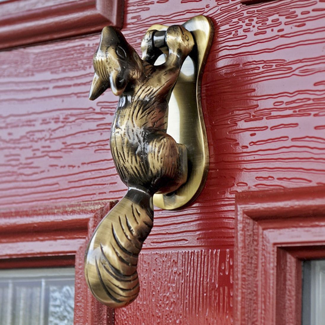 Antique Brass Squirrel door knocker on red door
