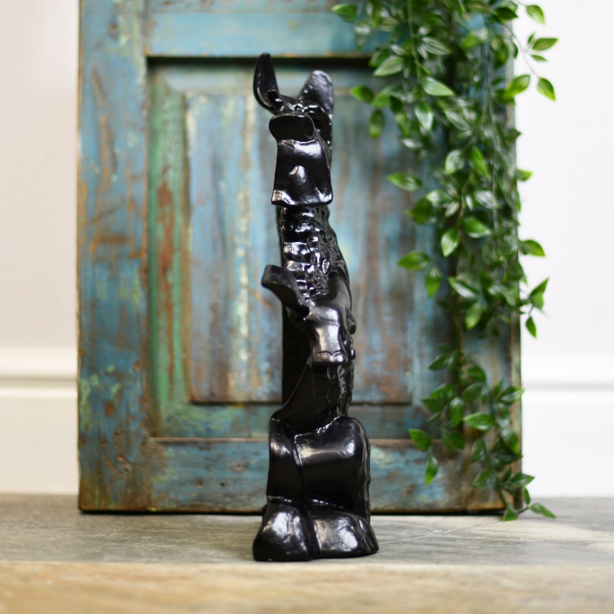 Side view of novelty black cast begging dog door porter