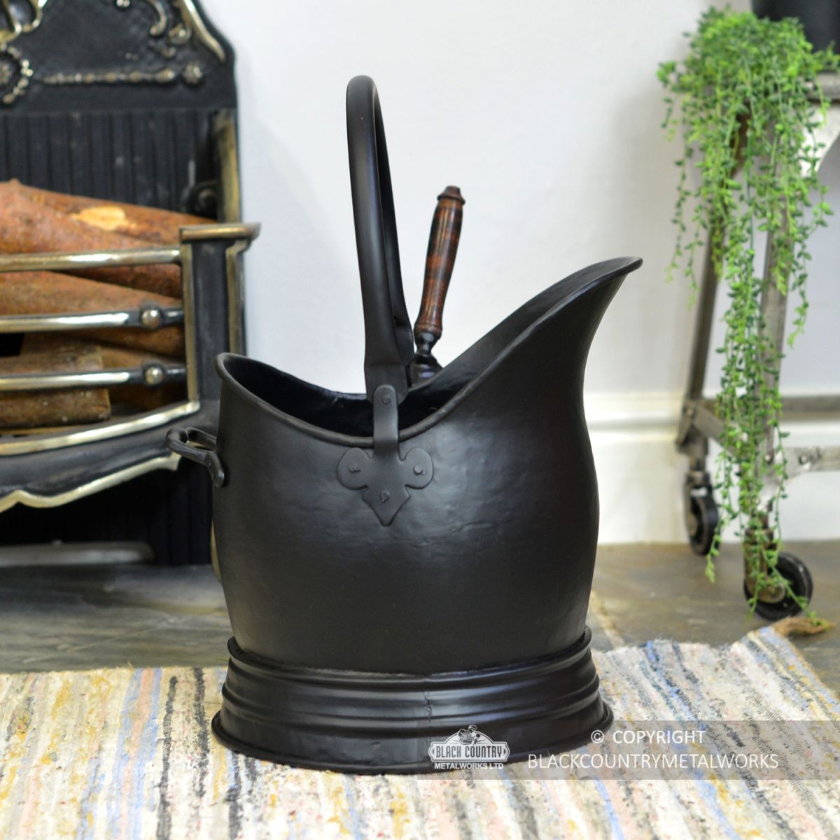 Side View of the Black Traditional Coal Bucket With Shovel