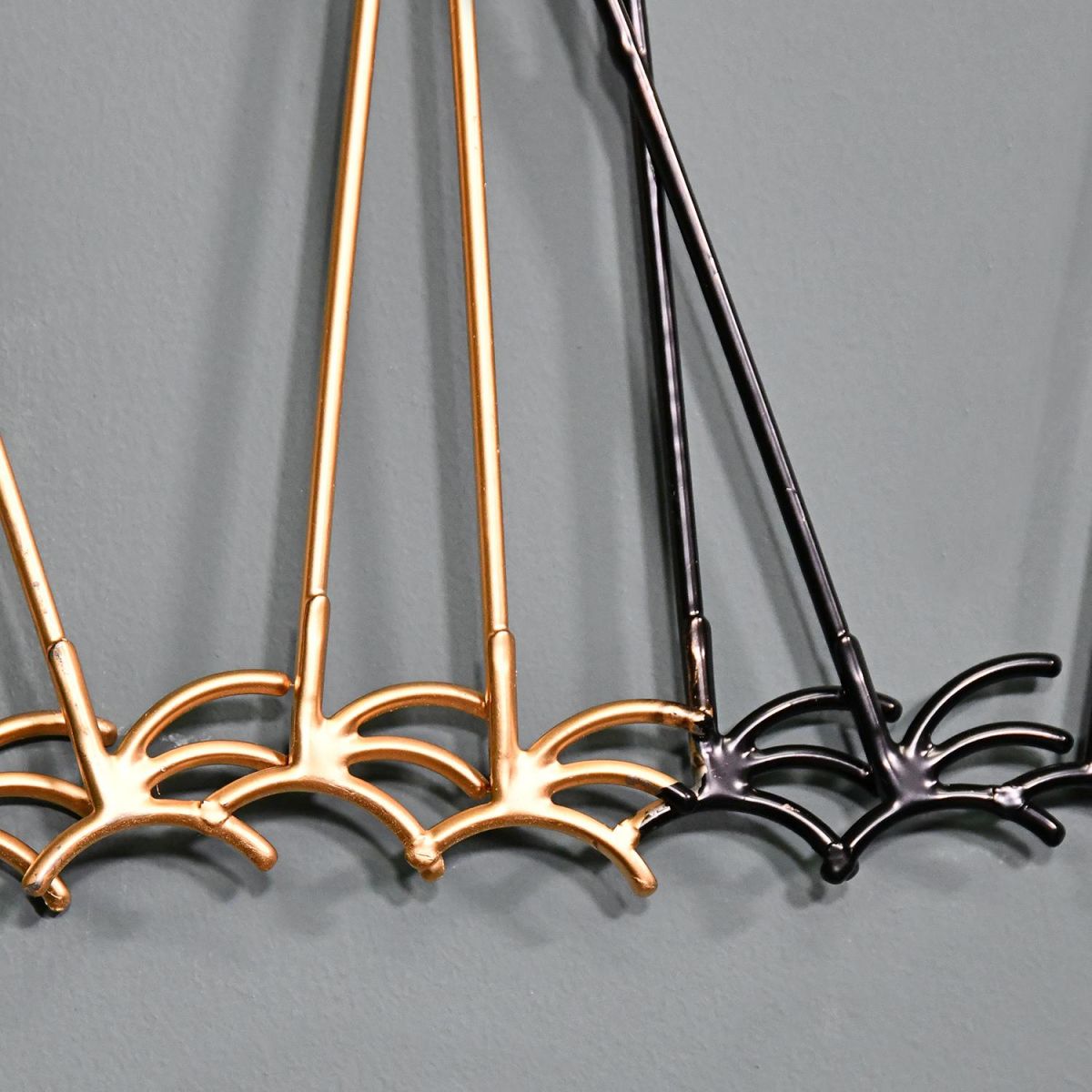 Close-up of the Brass and Black Feet on the Wall Art