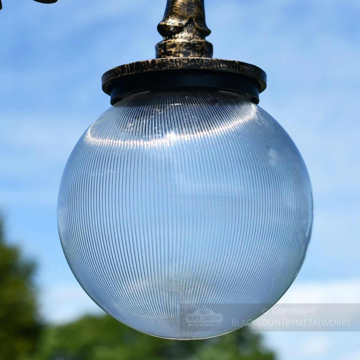 Fluted Globe Luminaire with gold ornate lamp post