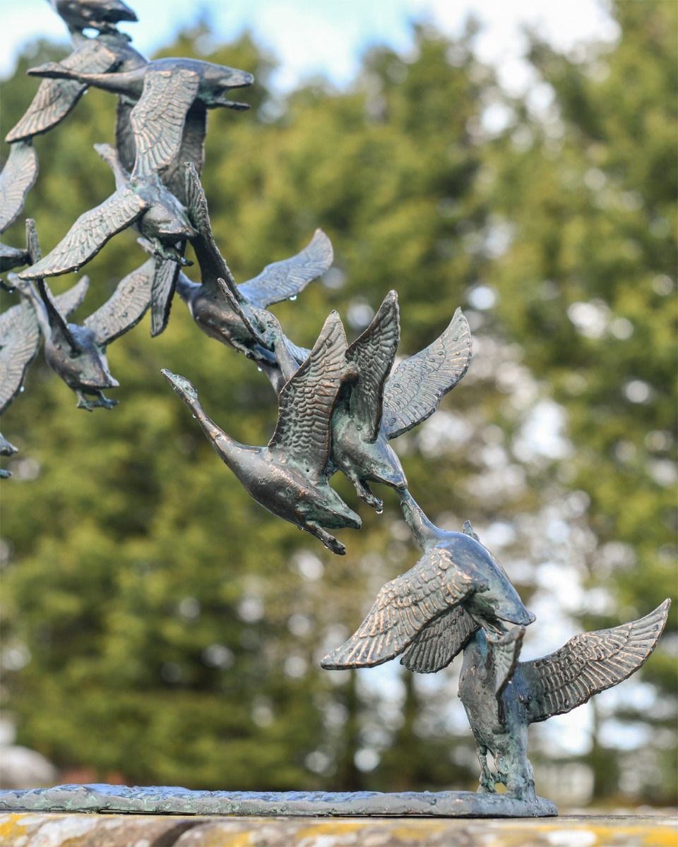 Close up of Flock of Flying Ducks Garden Sculpture 