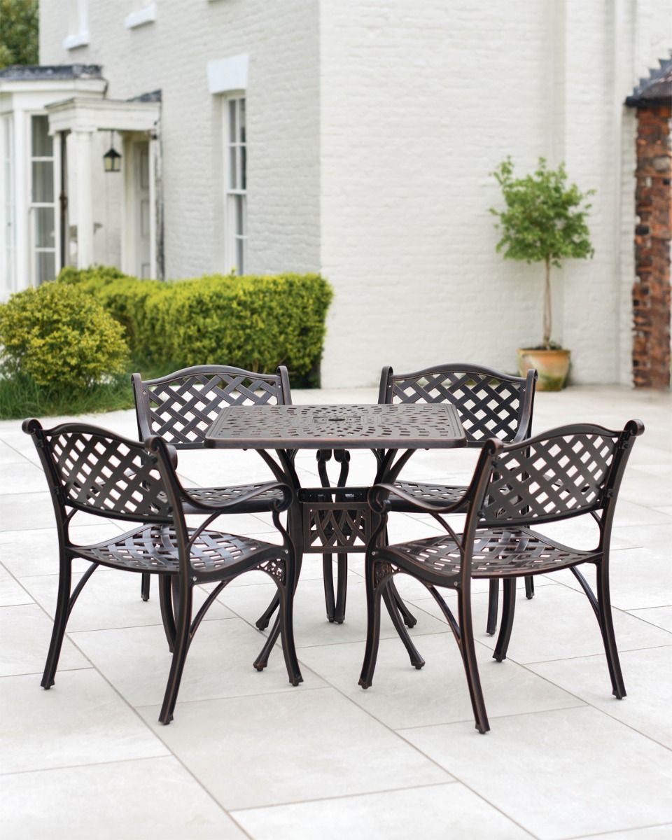 Four Chairs and Table In Garden 
