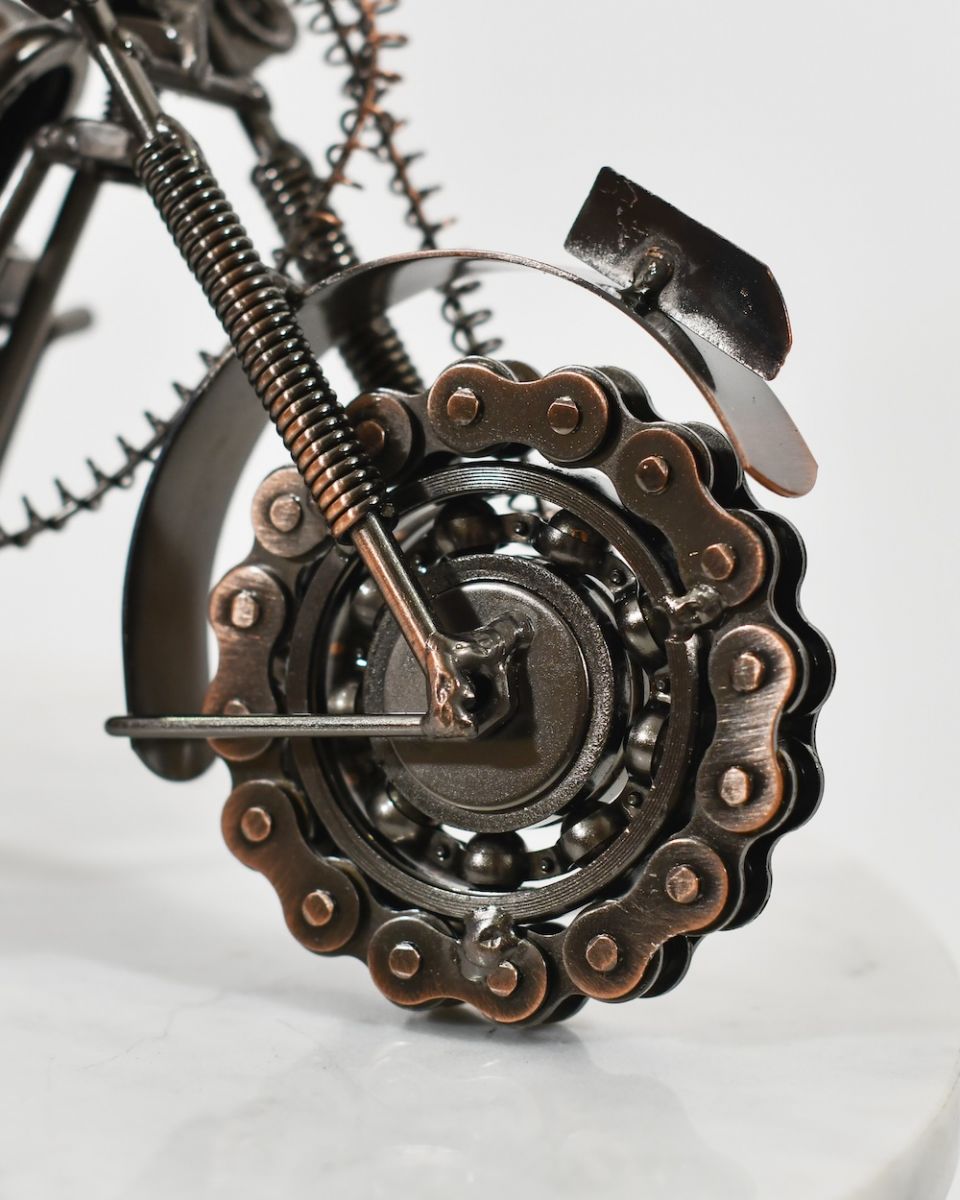 close up of front wheel on recycled metal motorbike sculpture