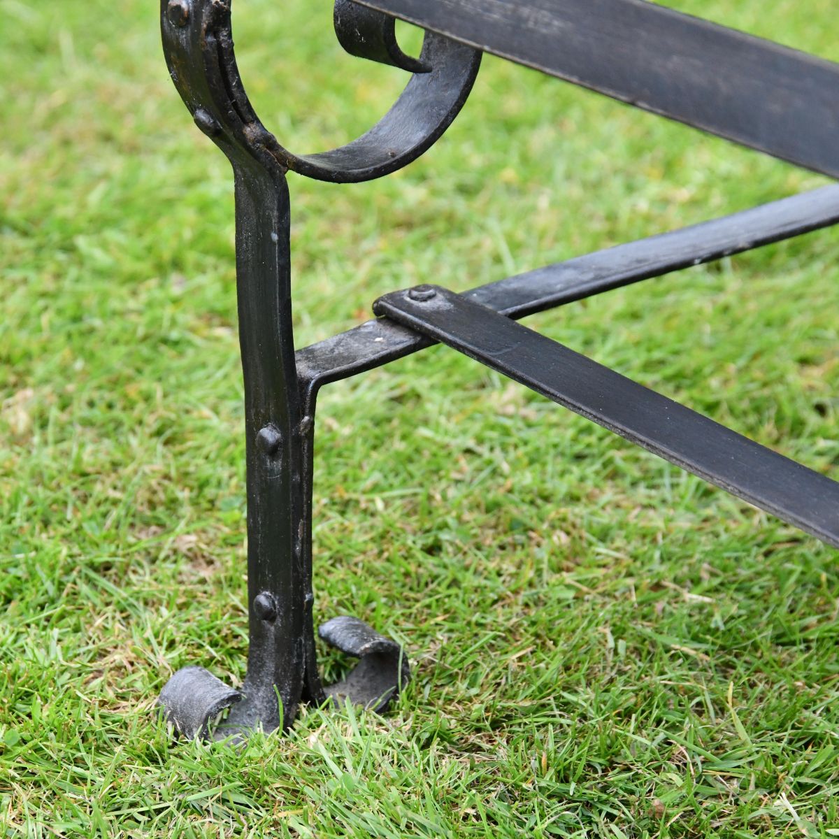 Black Two Seater Park Bench Feet Close-Up