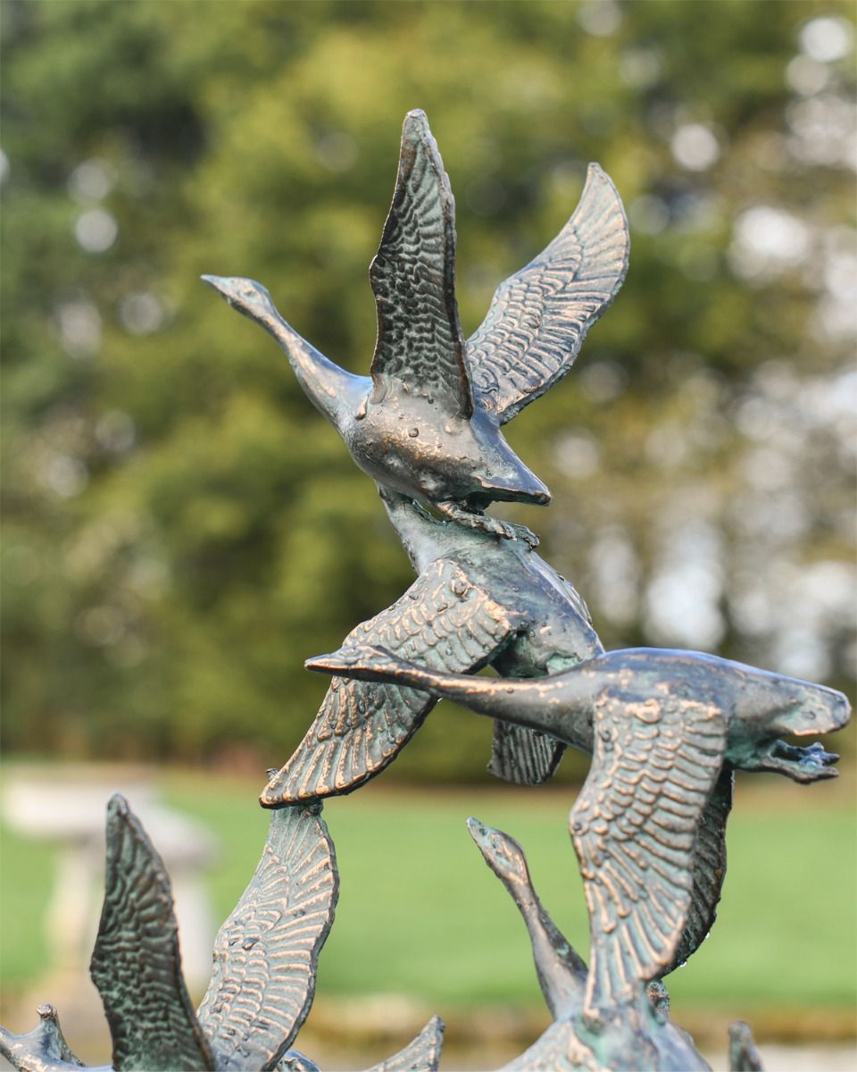 Close up of Flock of Flying Ducks Garden Sculpture 