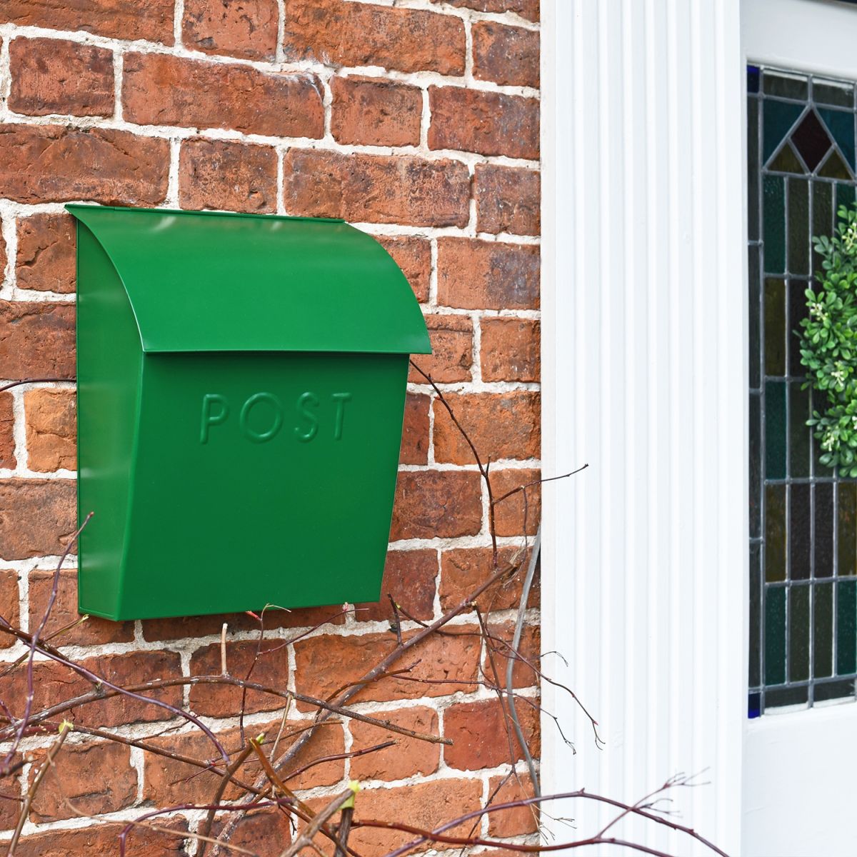 Green Contemporary Postbox in Situ on a Brick Wall