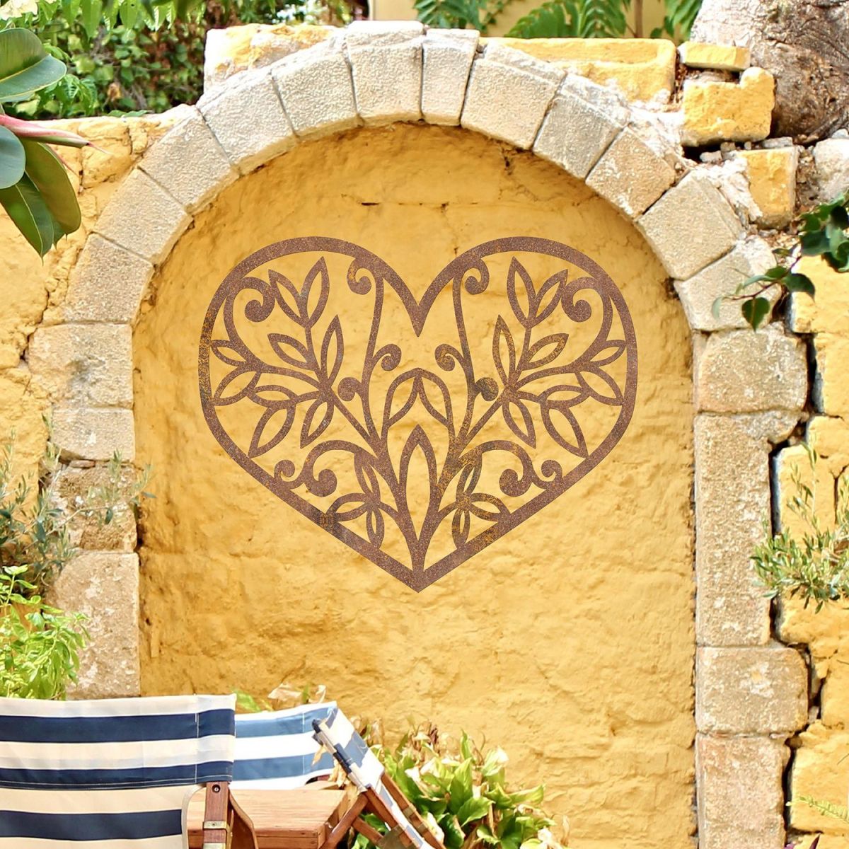 Flower Foliage Heart Wall Art in Situ in on a Yellow Garden Wall