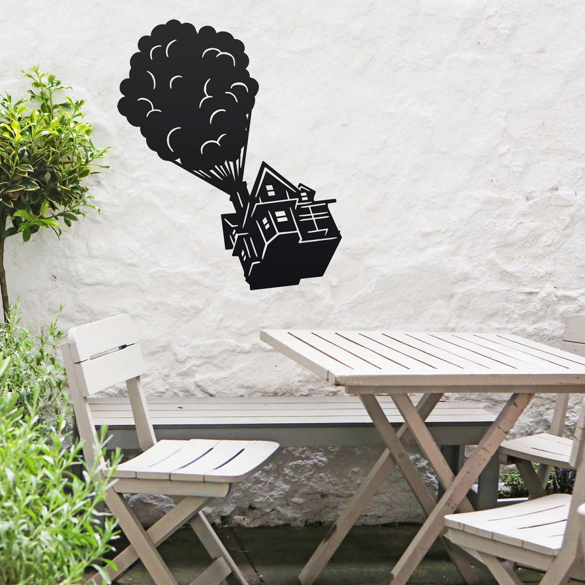 Floating House on Balloons Steel Wall Art above a Wooden Table set