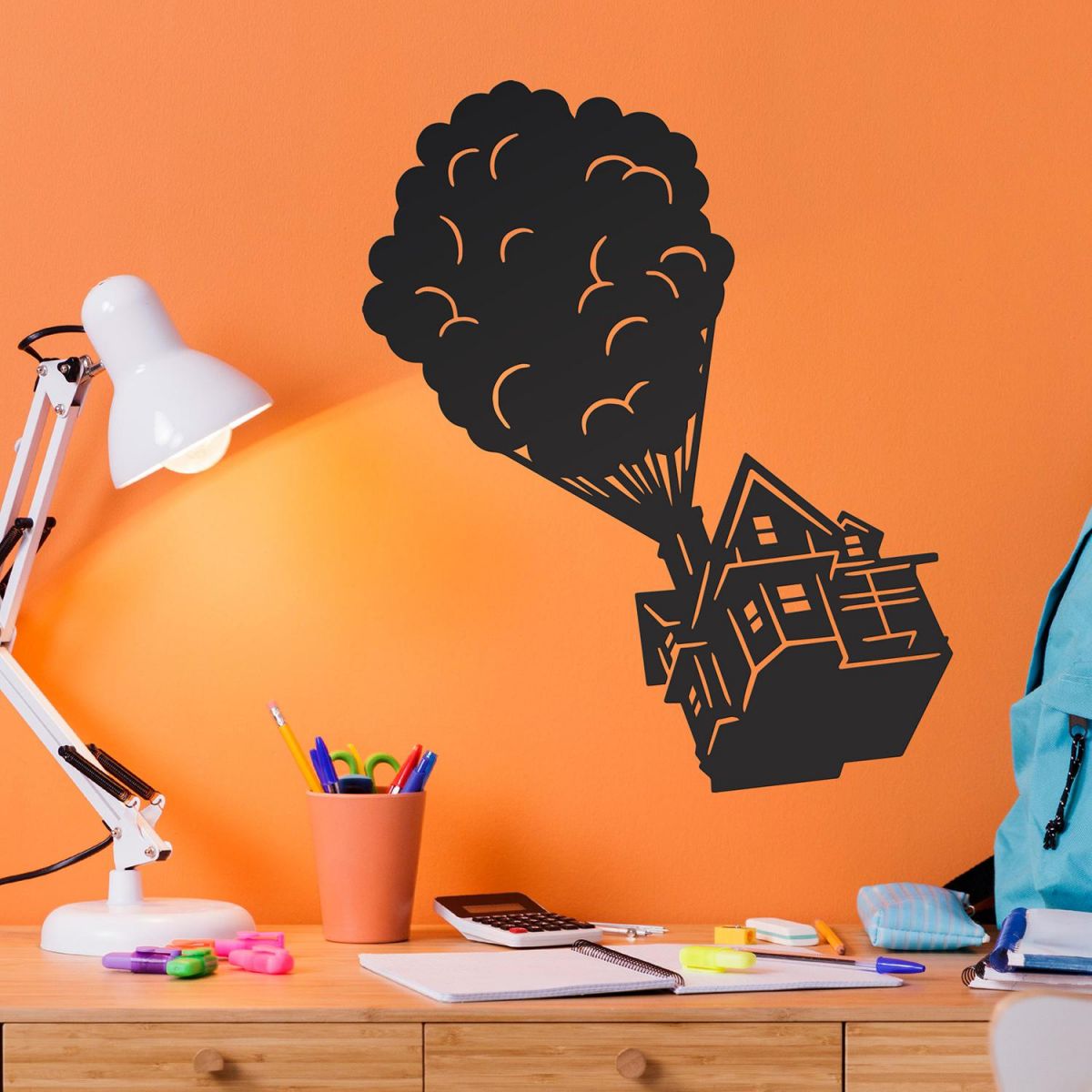 Floating House on Balloons Steel Wall Art in Situ on an Orange Wall