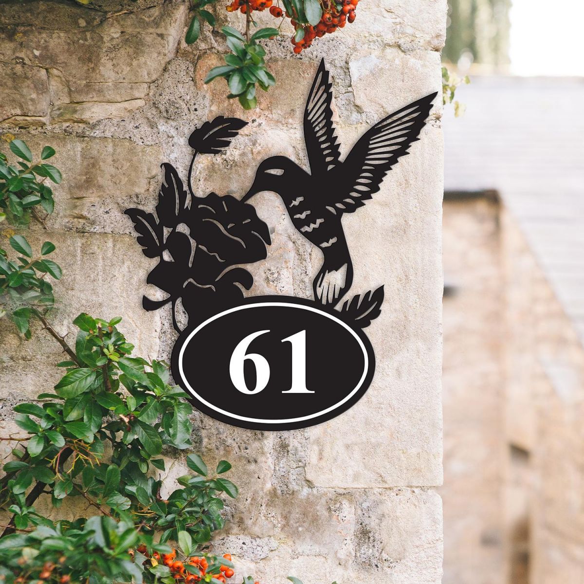 Bespoke Hummingbird Iron House Number Sign on a Garden Wall