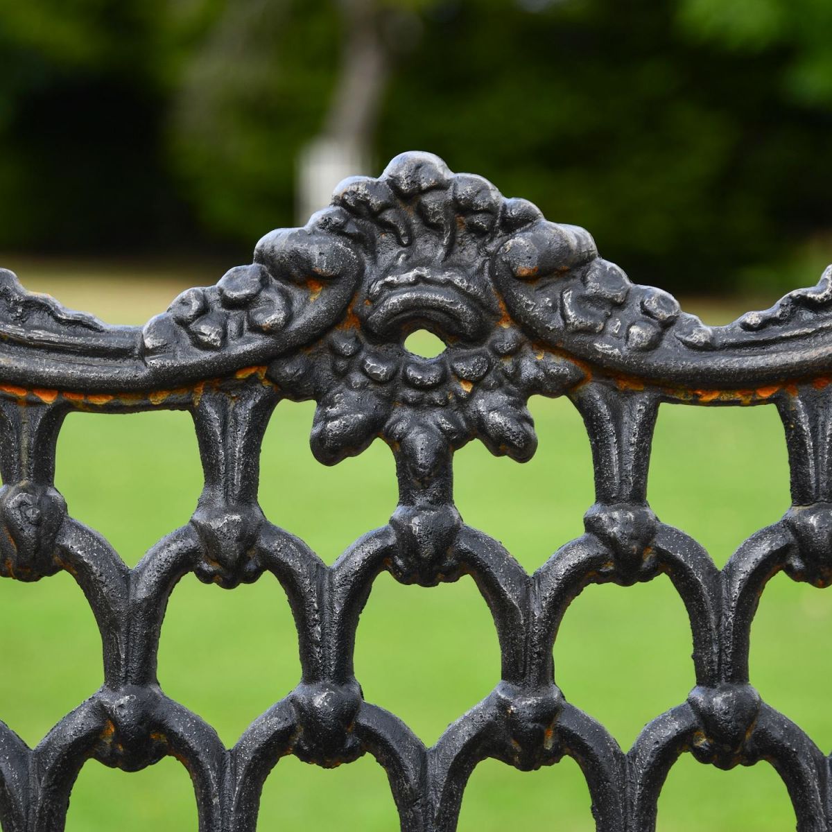 Close up of decorative motif on backrest of garden bench 