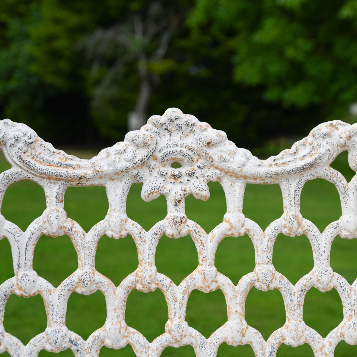 Close up of Antique Cream Cast Iron Bench Backrest