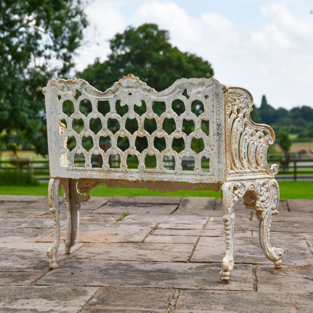 Rear view of Antique Cream Cast Iron Garden Bench in Situ