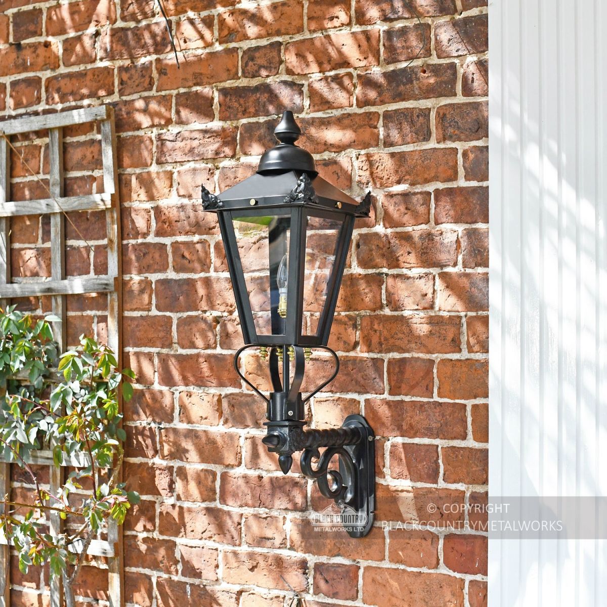 Lantern on royal bracket mounted on brick wall