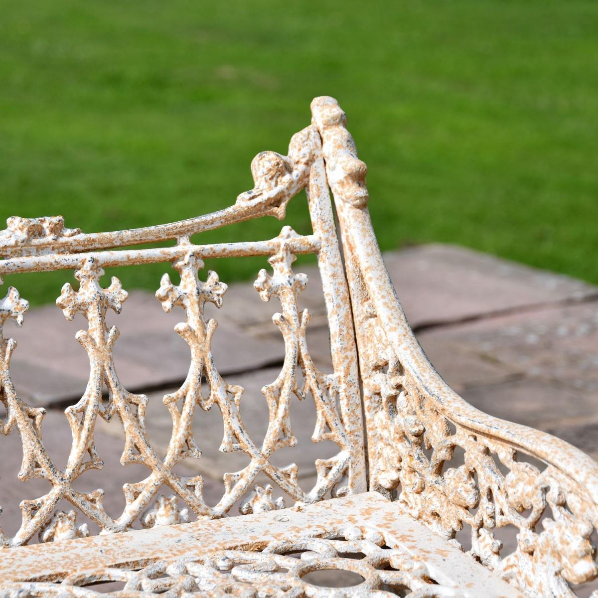 Close up of armrest and backrest on Antique Cream Cast Iron Gothic Three Seater Bench