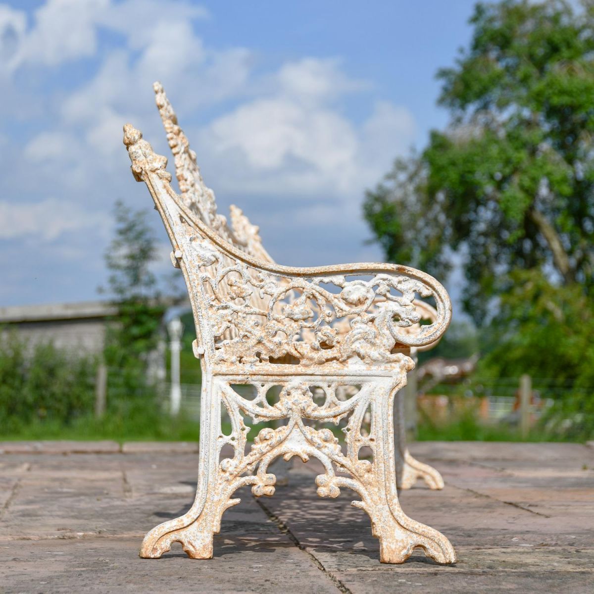 Side view of Gothic design on Antique Cream Cast Iron Three Seater Bench