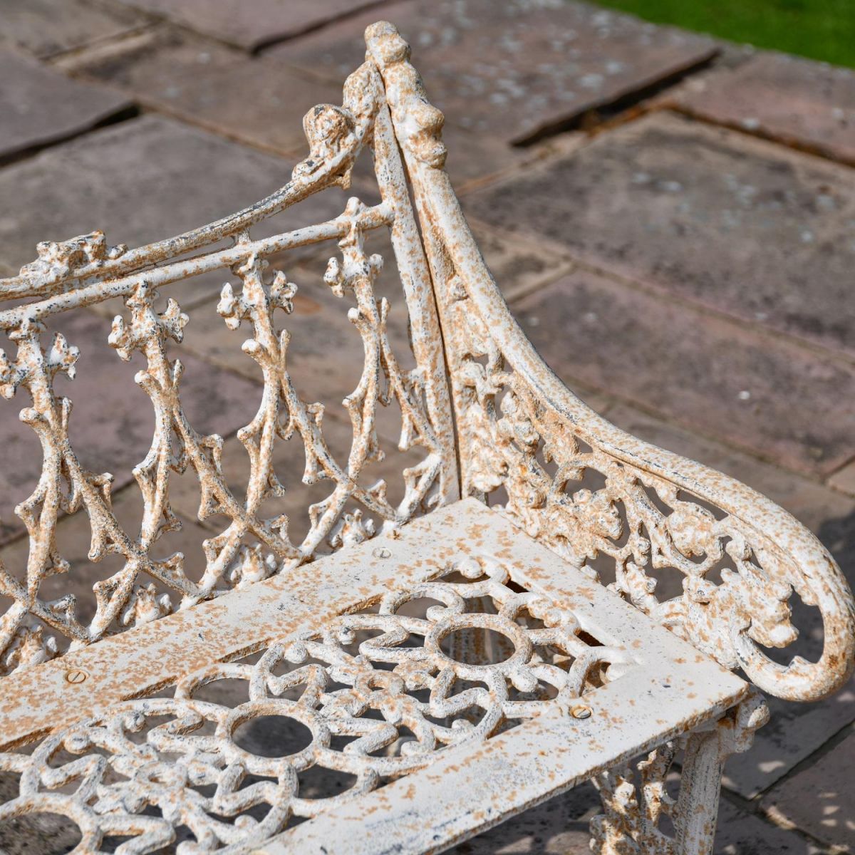 Close up of Antique Cream Cast Iron Bench