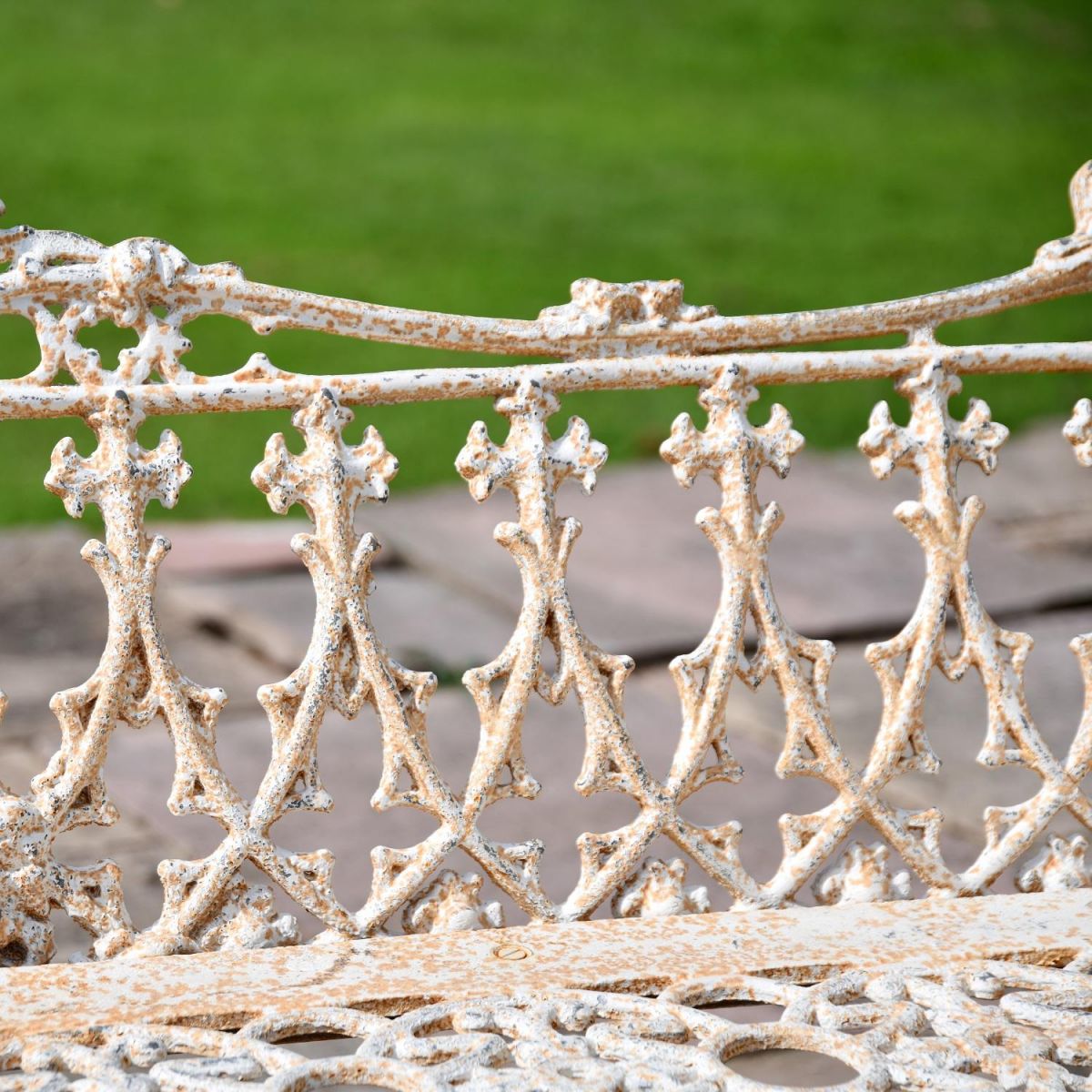 Close up of Antique Cream Cast Iron Gothic Garden Bench