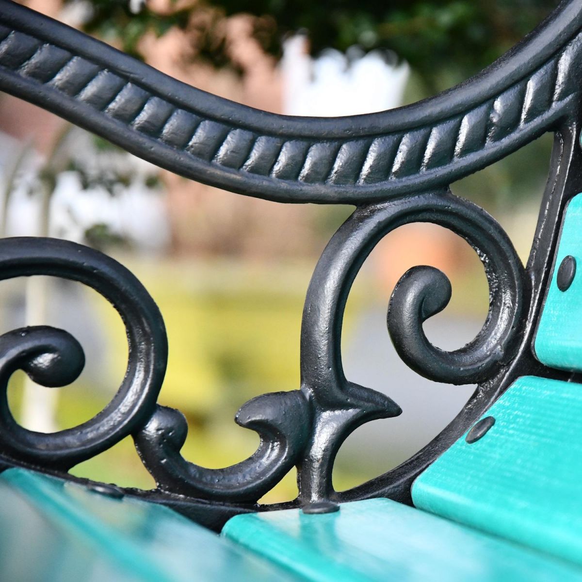 Close up of scroll work on bench armrest