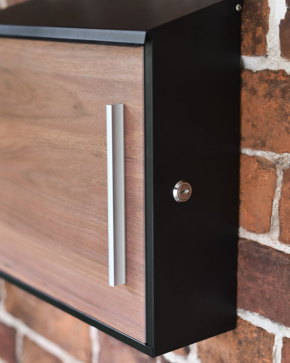 Close up Of The Lockable Front Door On A Modern Wall Mounted Post Box