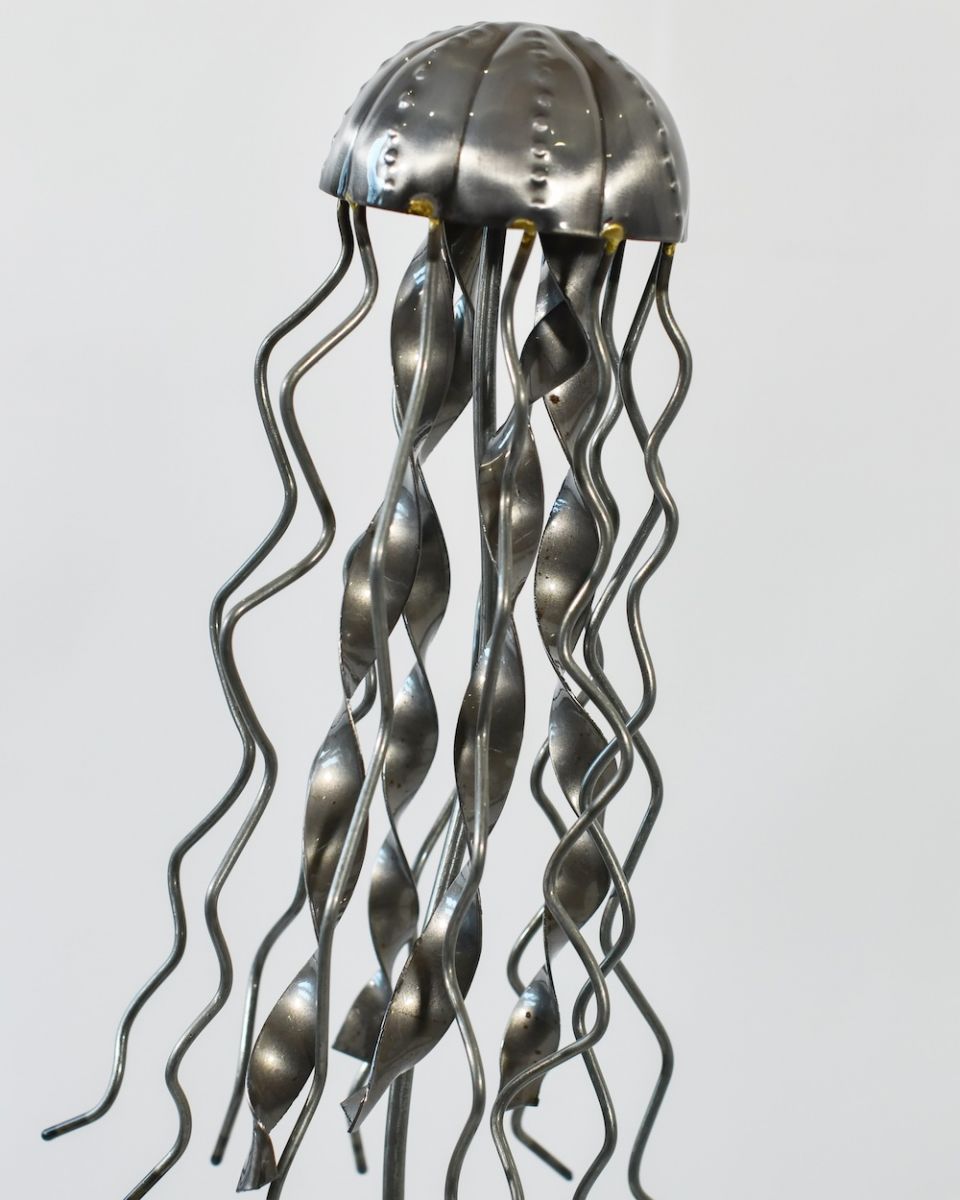 Close up of intricate jellyfish detail on recycled metal art sculpture