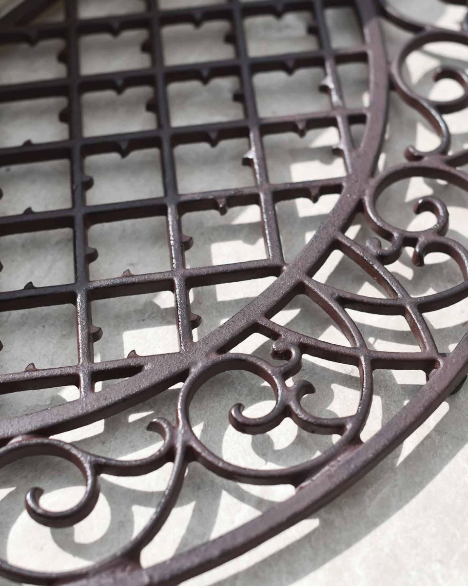 Close-Up of Ornate Pattern on Arched Doormat