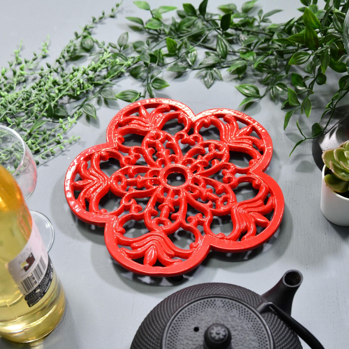 Red Cast Iron Flower Petal Trivet in Situ with Teapot
