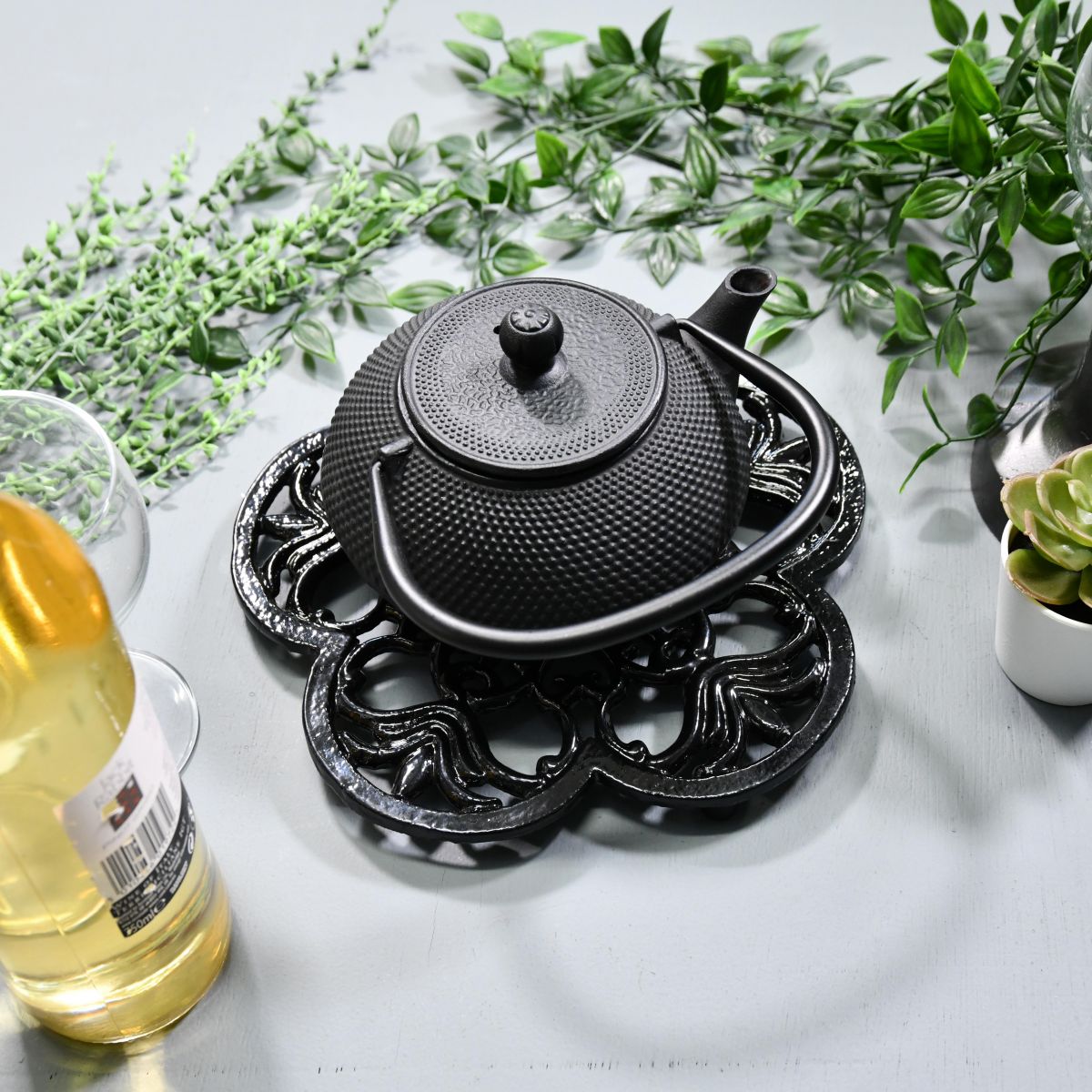 Black Cast Iron Flower Trivet in Use with Teapot