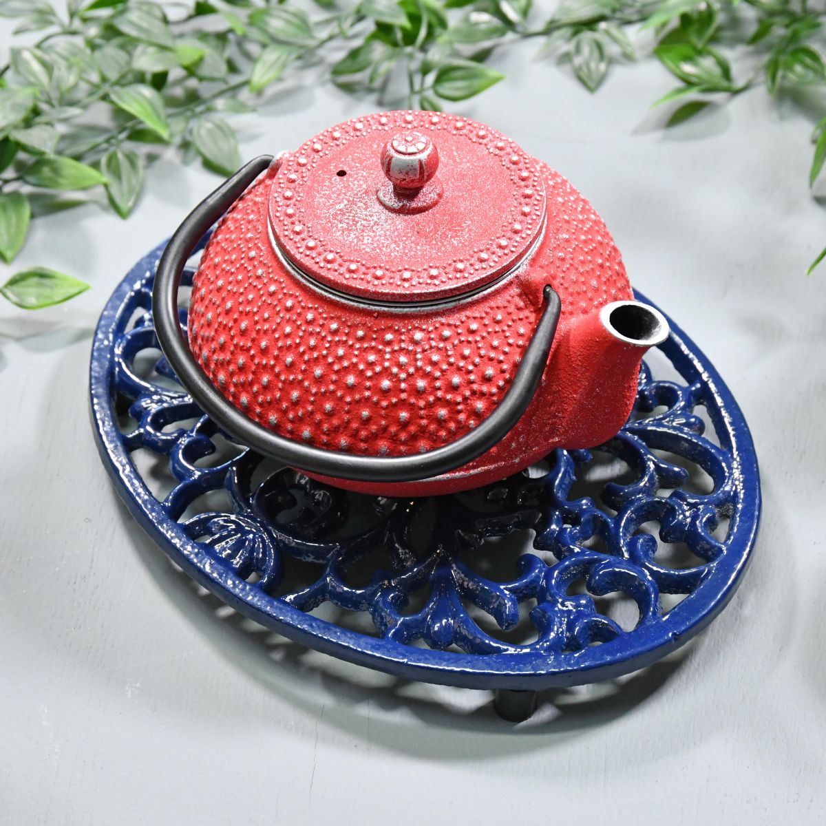 Blue Cast Iron Oval Trivet in Use with Teapot