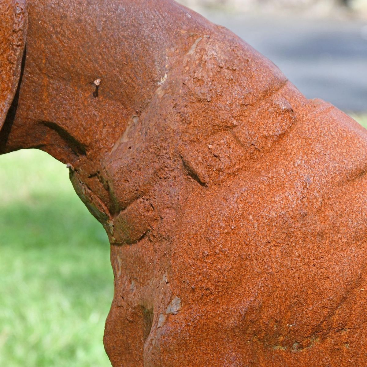 Close up of rustic finish and collar on dog sculpture 