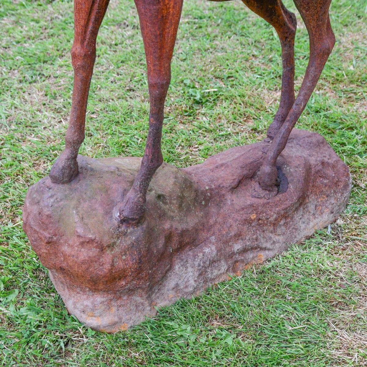 Close up of cast iron plinth on which stag sculpture stands