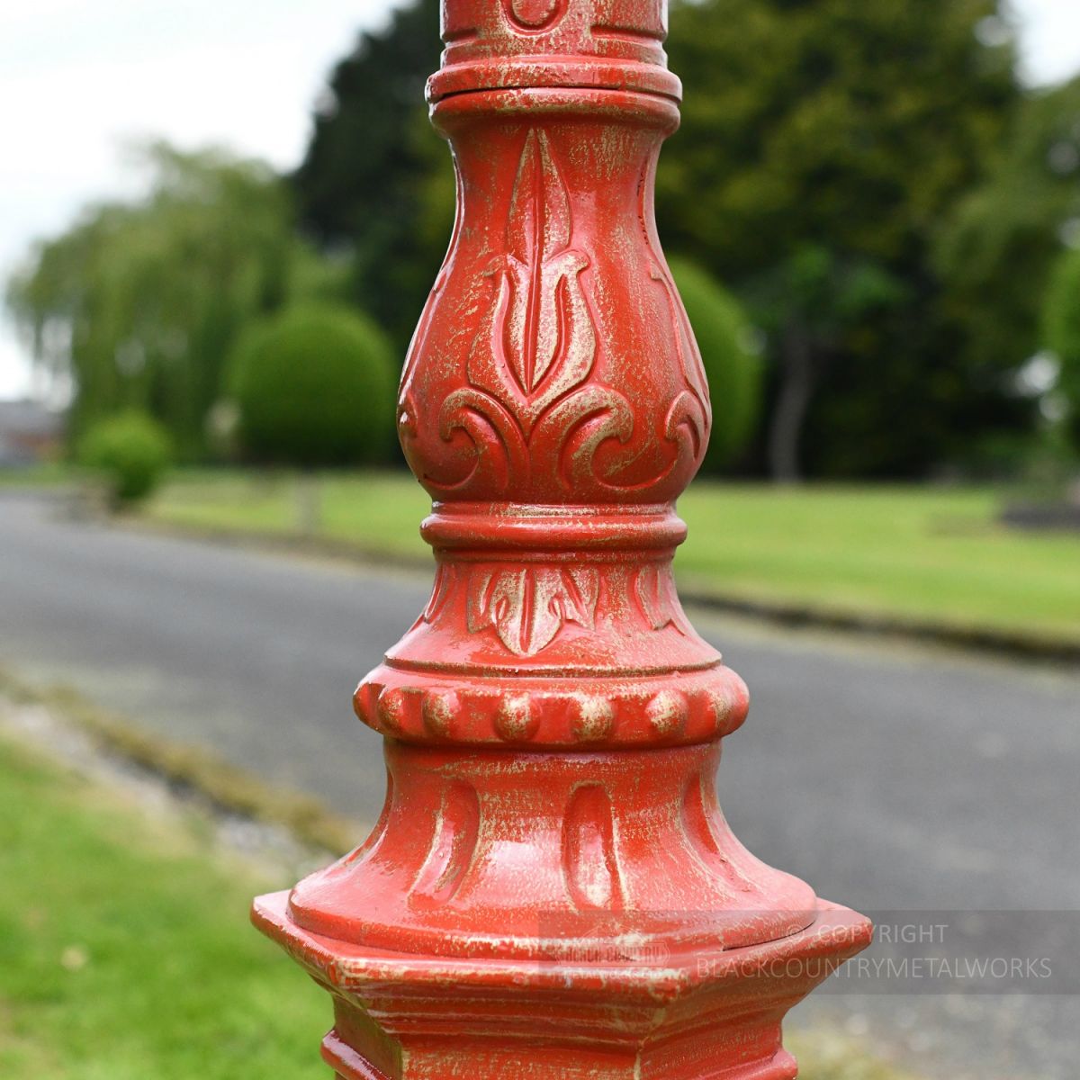 Ornate detailing on red lamp post