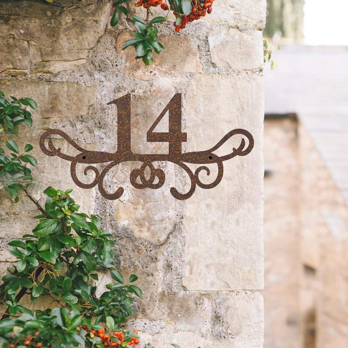 Ornate Scroll Iron House Number Sign on a Rustic Wall